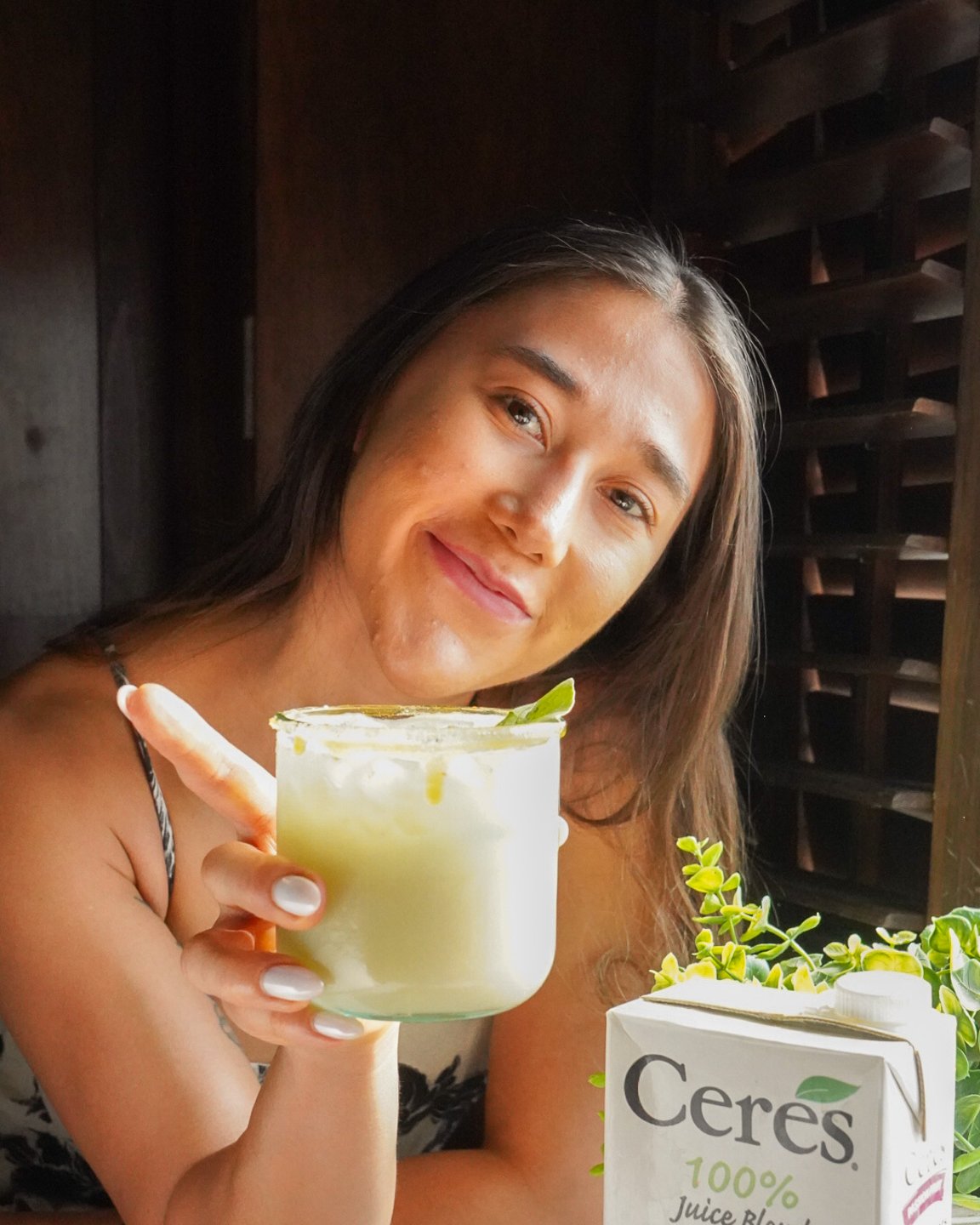Maria with her passion fruit margarita and a partner brand's product